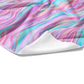 Plush white cotton towel with ocean blue, lavender, purple, and pink tie dye mermaid stripe print on the front.