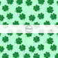 Light green fabric by the yard with dark green scattered shamrocks