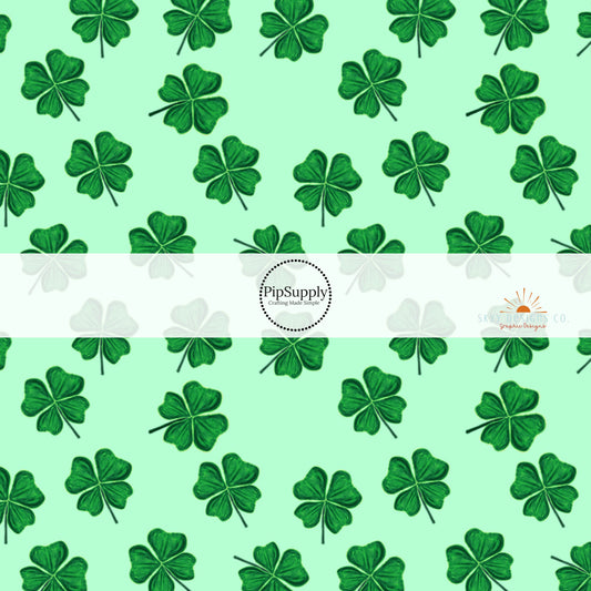 Light green fabric by the yard with dark green scattered shamrocks