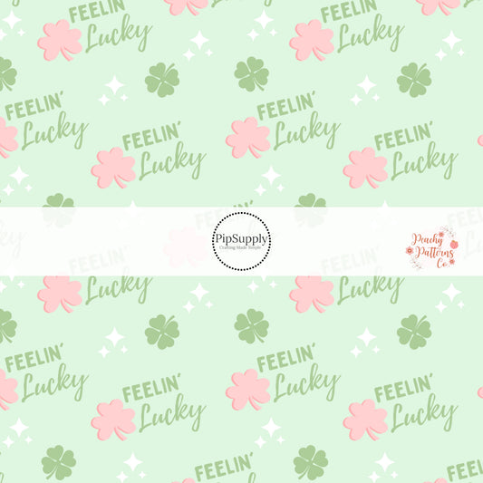 Light Green fabric with pink and green shamrocks and the phrase "Feelin' Lucky"