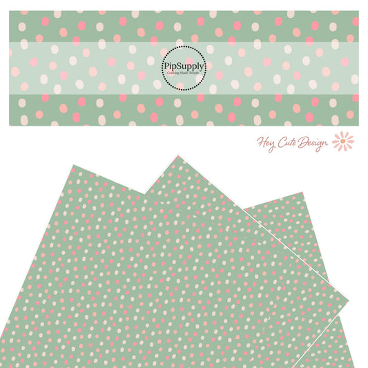 Pink, peach, hot pink dots on a mint green pattern faux leather sheet.