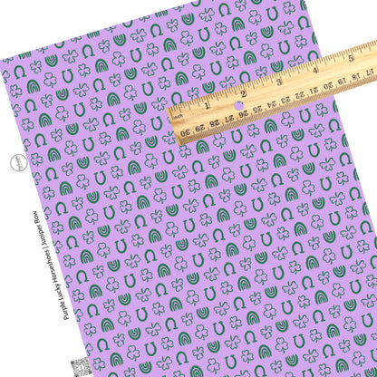 Green outlined clover, rainbows, and horseshoe with polka dots on a purple faux leather sheet