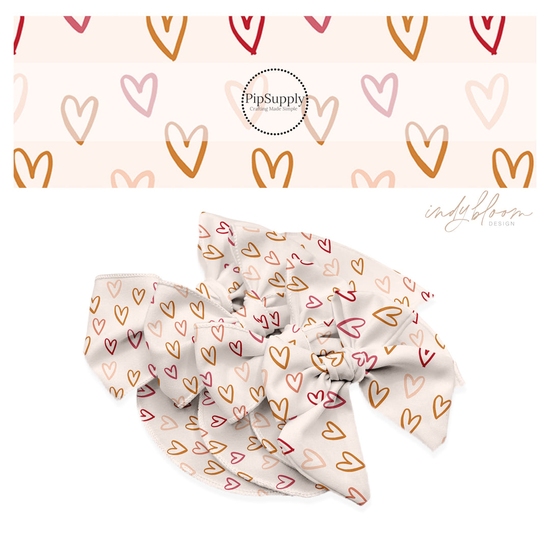 Pink and gold valentine hollow hearts on a cream bow strip