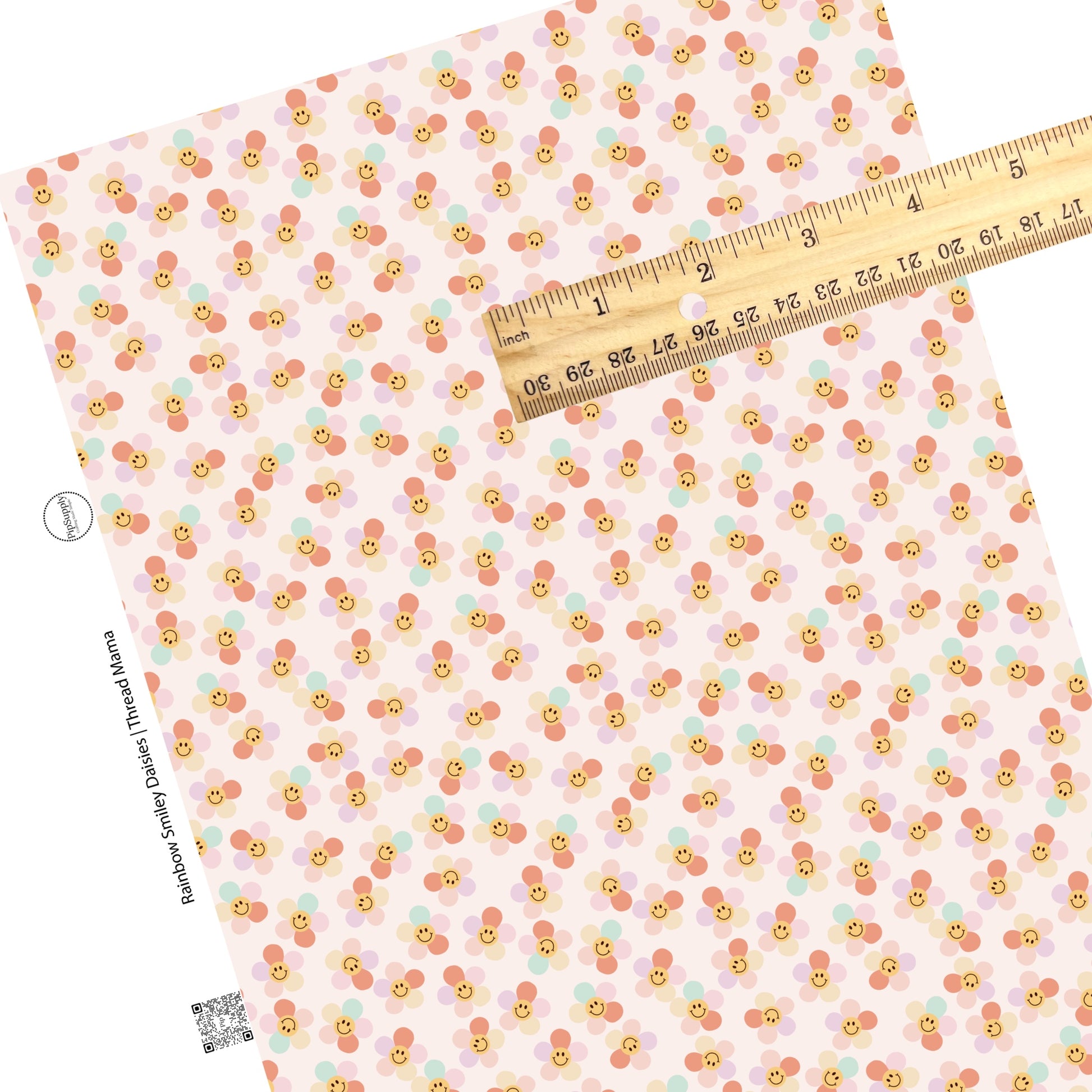 Scattered daisies with rainbow petals and smiley face on a pink faux leather sheet