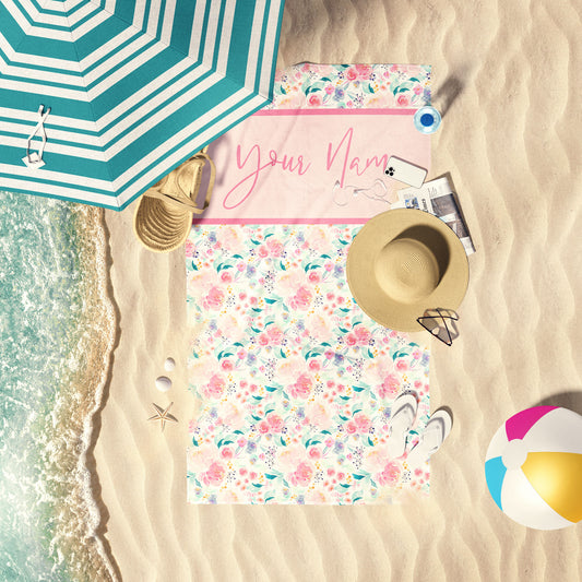 Mermaid Pastel Floral print beach towel laid out by the water at the beach.