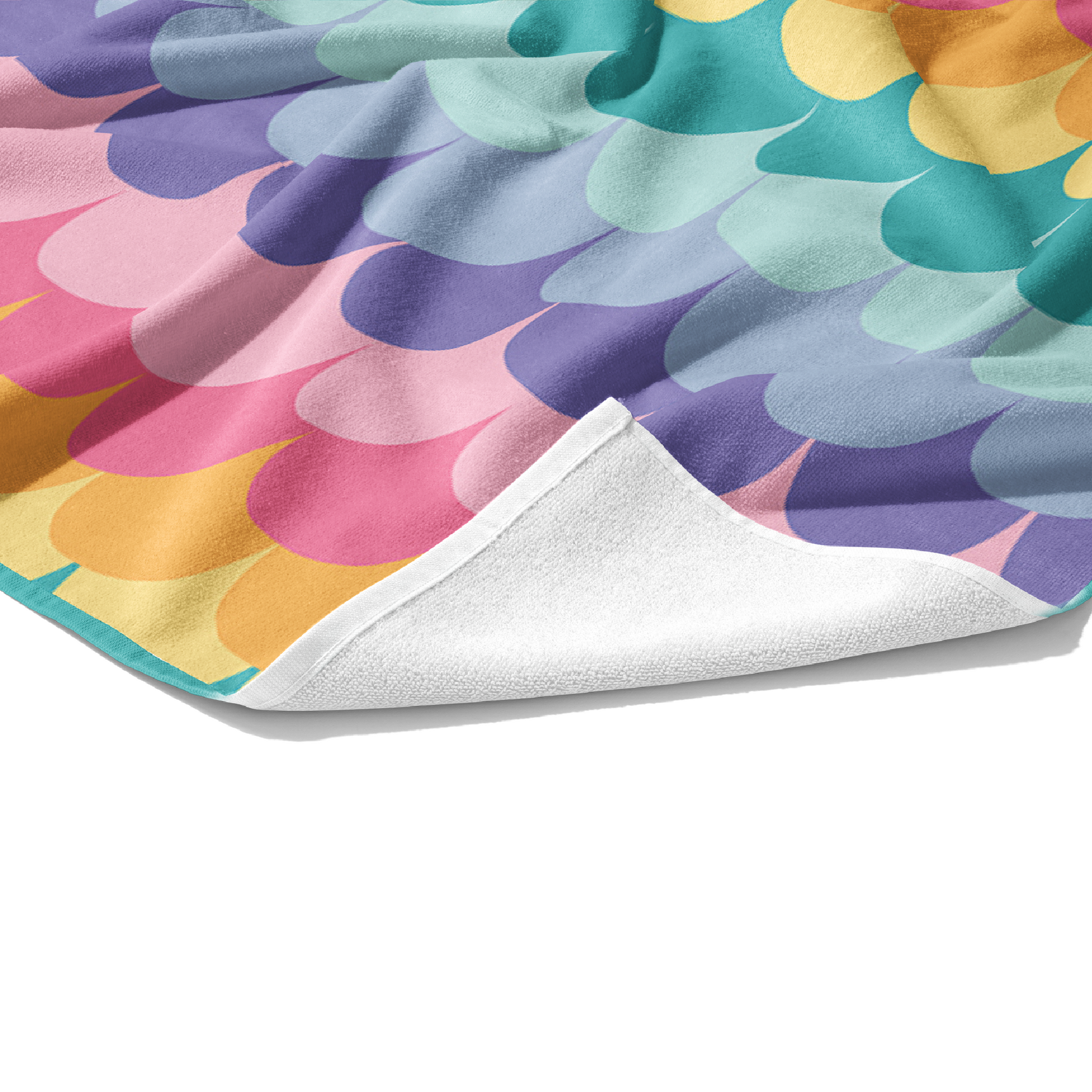 Plush white cotton towel with aqua, light blue, lavender, purple, light pink, pink, orange, and yellow rainbow mermaid scales print on the front.