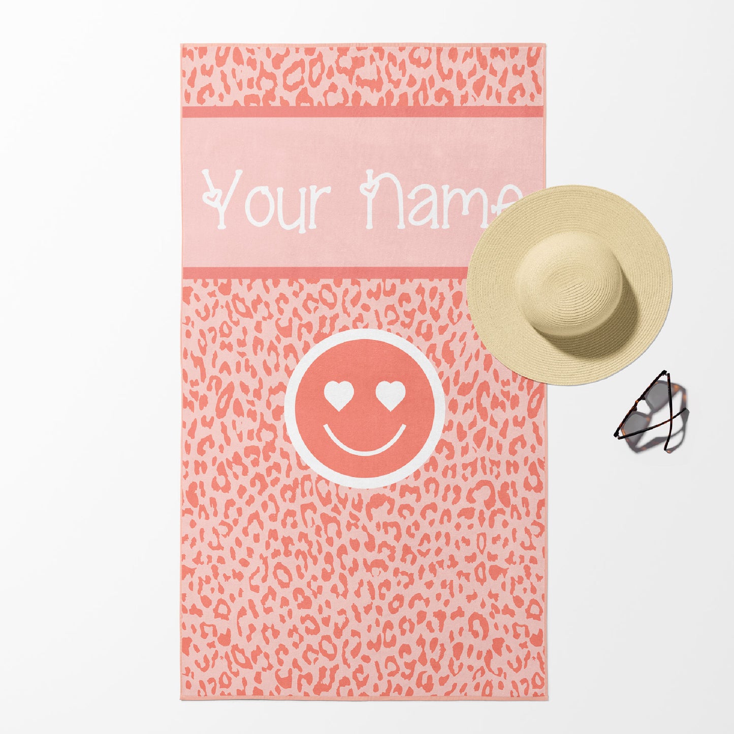 Beach towel in peach leopard print with smiley face and customizable text.