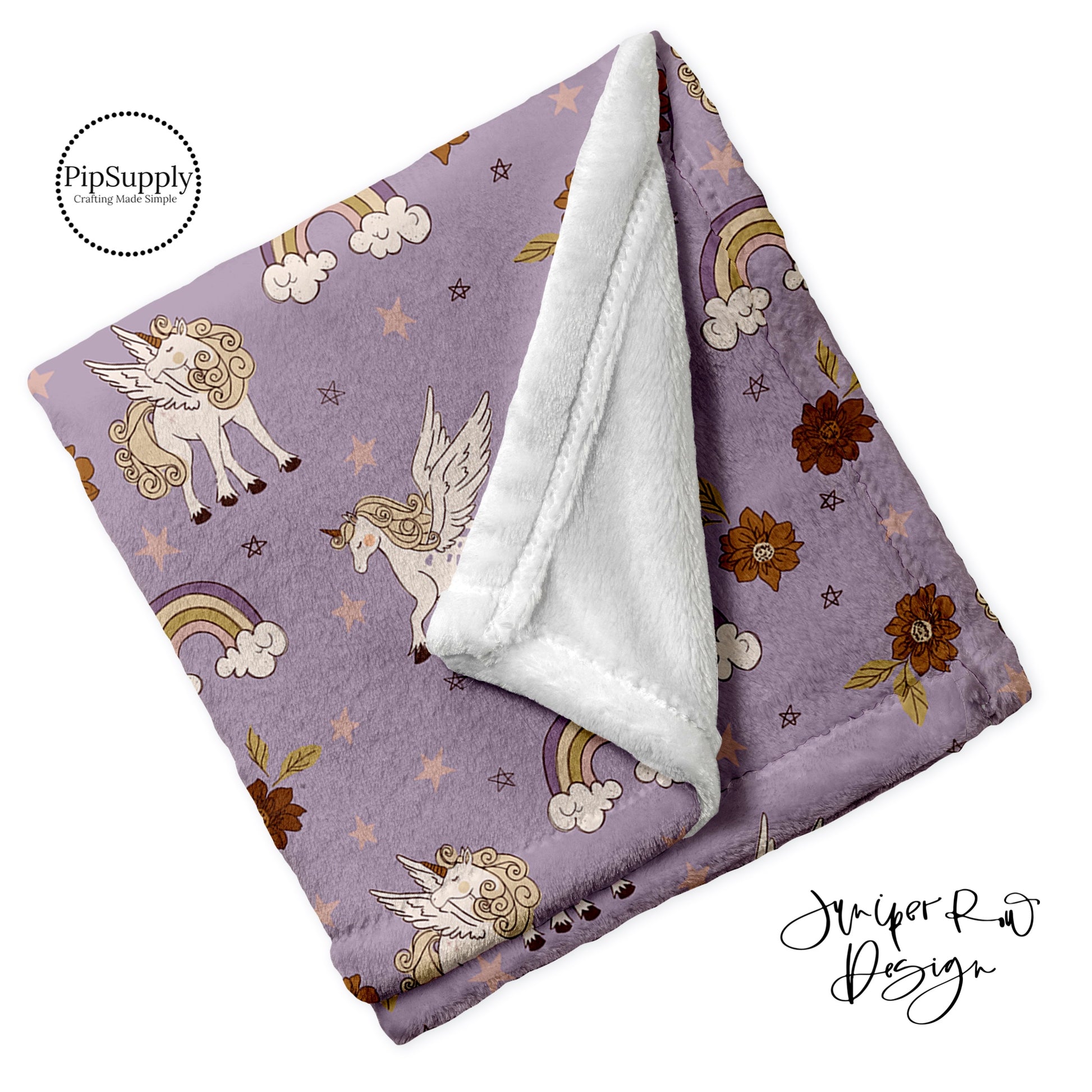 Soft folded minky furr blanket in purple rainbows and unicorn Pegasus pattern.