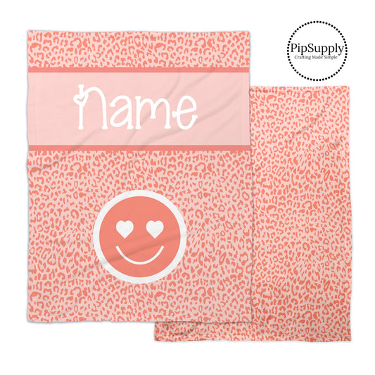 Peachy pink leopard print patterned soft minky blanket with smiley face and customizable text.