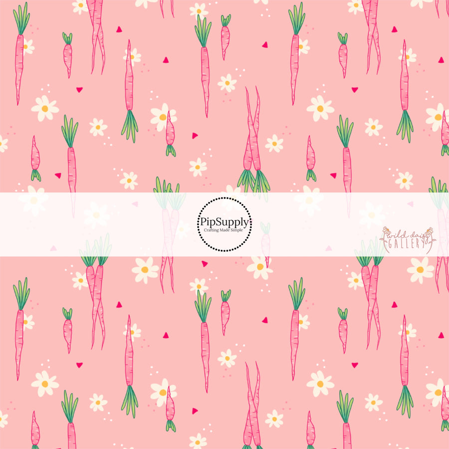 Pink fabric by the yard with pink scattered carrots and white flowers