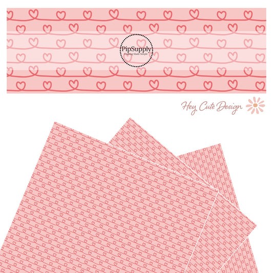 Pink hearts in a line drawing on pink faux leather sheet