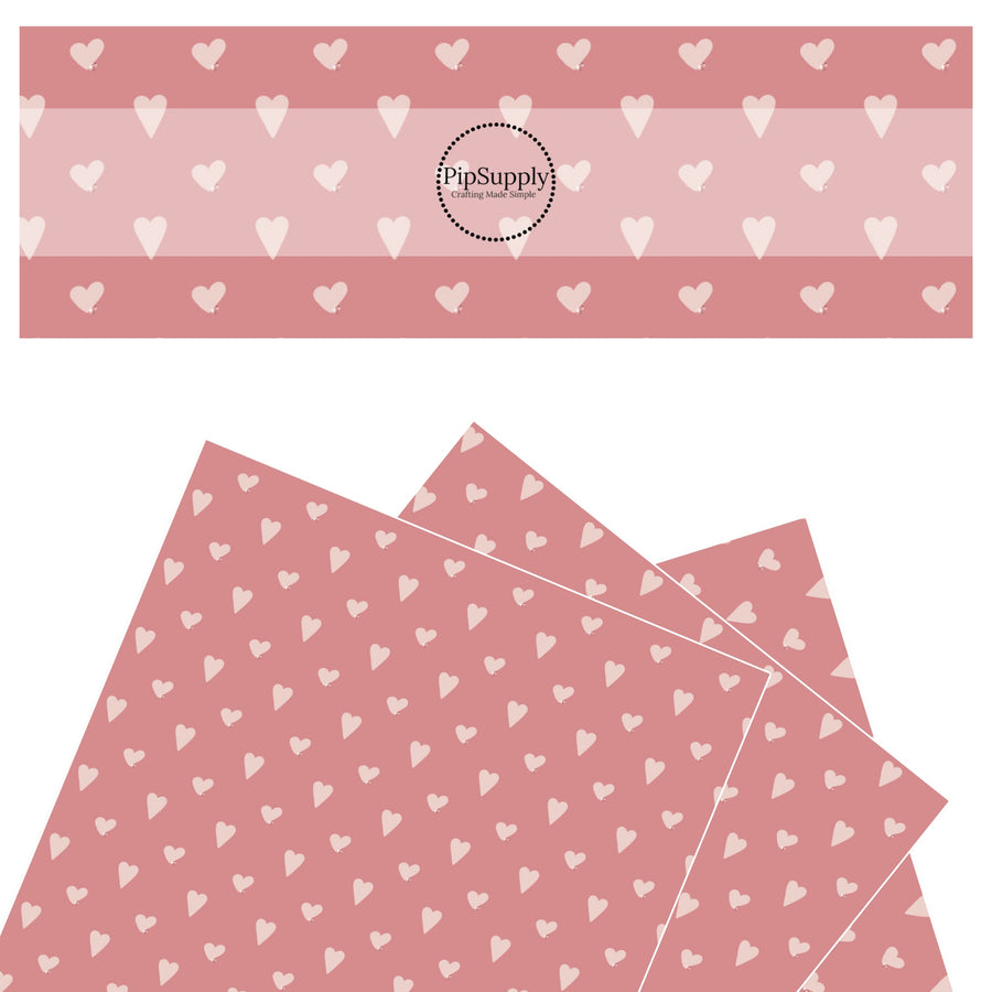 Scattered pink hearts on pink faux leather sheet.