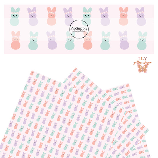Aqua, purple, and pink bunnies wearing floral crowns on pink faux leather sheet