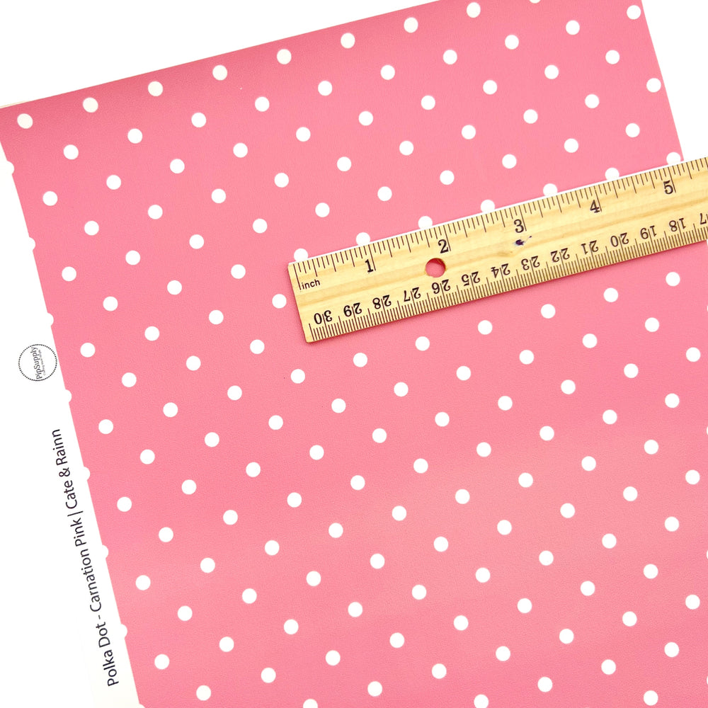 White polka dot on pink faux leather sheet.