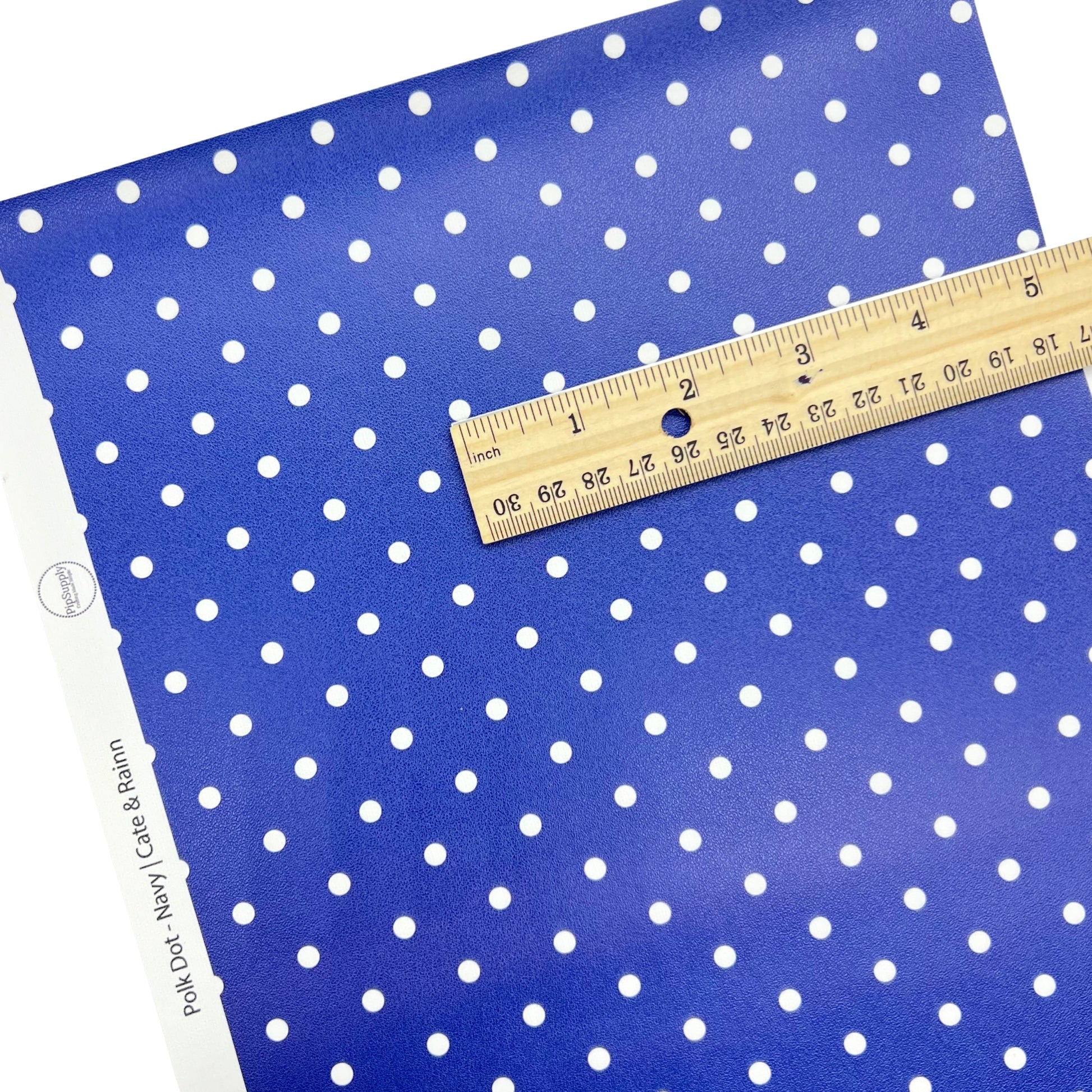 White dots on navy faux leather sheet.