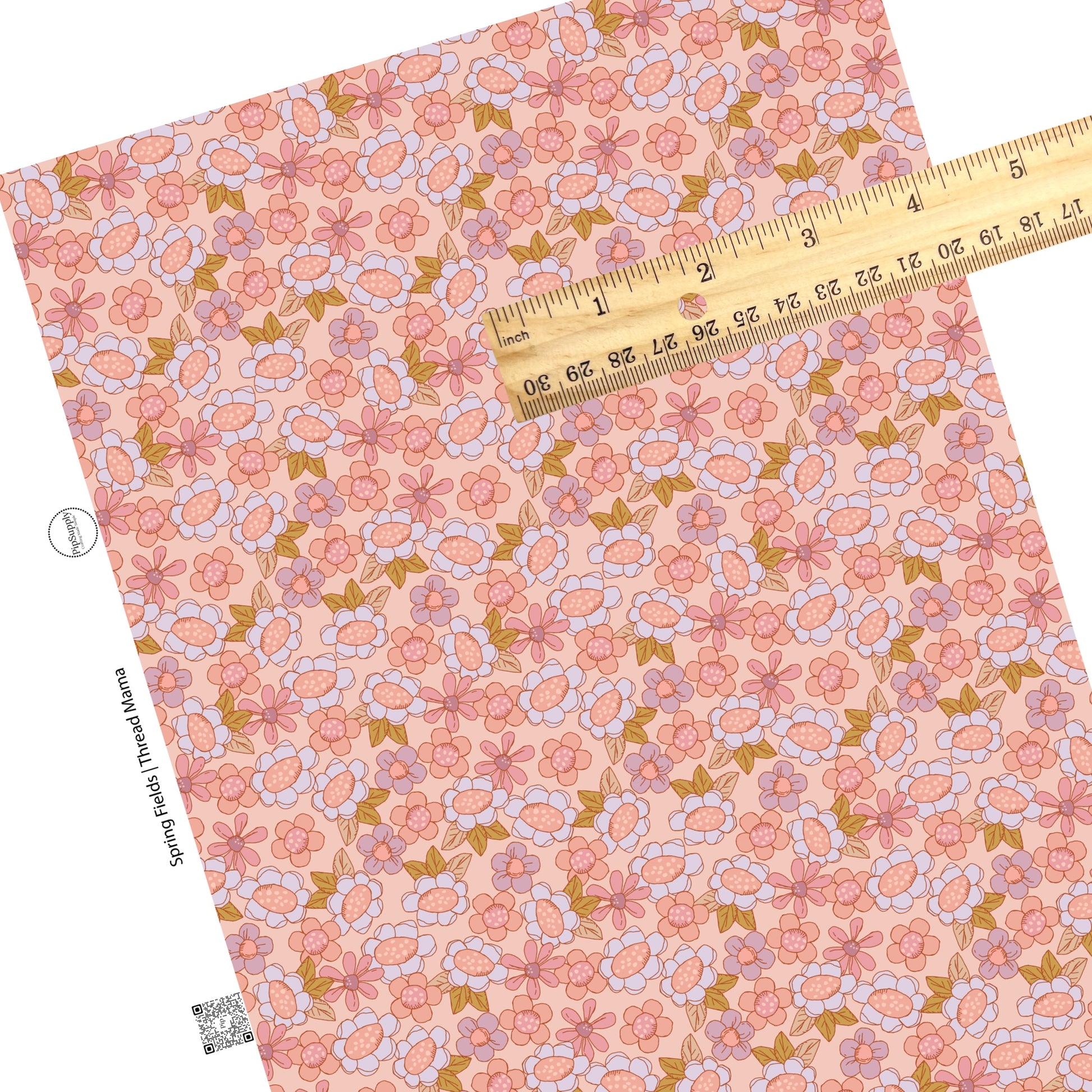 Field of pink and purple flowers with pink centers and green leaves on a pink faux leather sheet