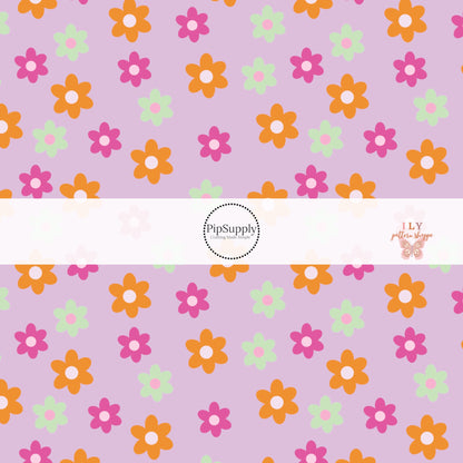 Green, orange, and pink flowers on a lavender bow strip