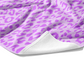 Plush white cotton towel with lavender and purple leopard animal print on the front.