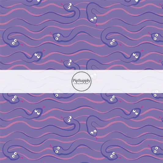 purple animated snakes on pink and purple fabric by the yard