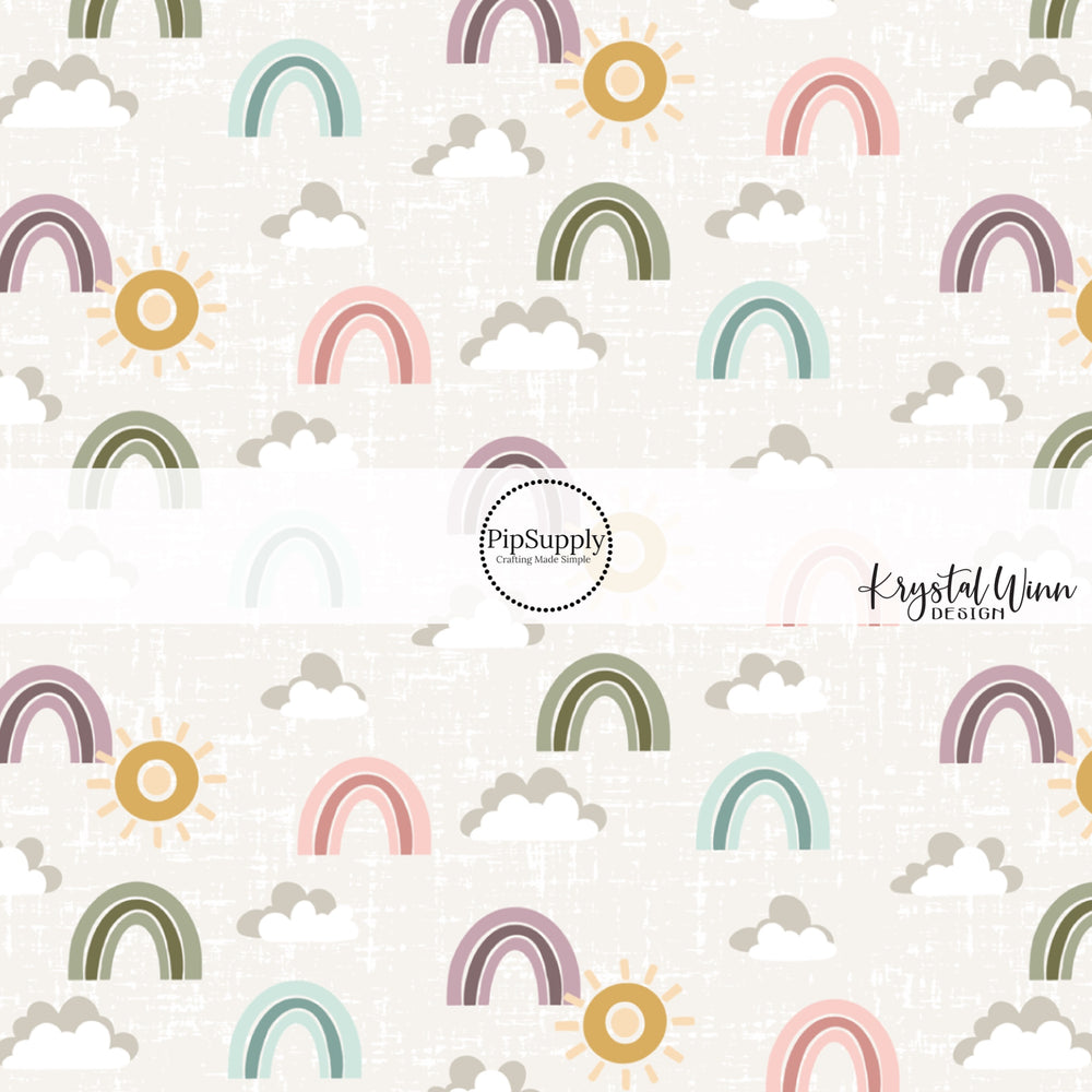 Gray and white clouds with green, blue, pink, and purple rainbows and gold sunshine on a gray distressed bow strip