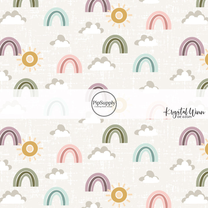 Gray and white clouds with green, blue, pink, and purple rainbows and gold sunshine on a gray distressed bow strip