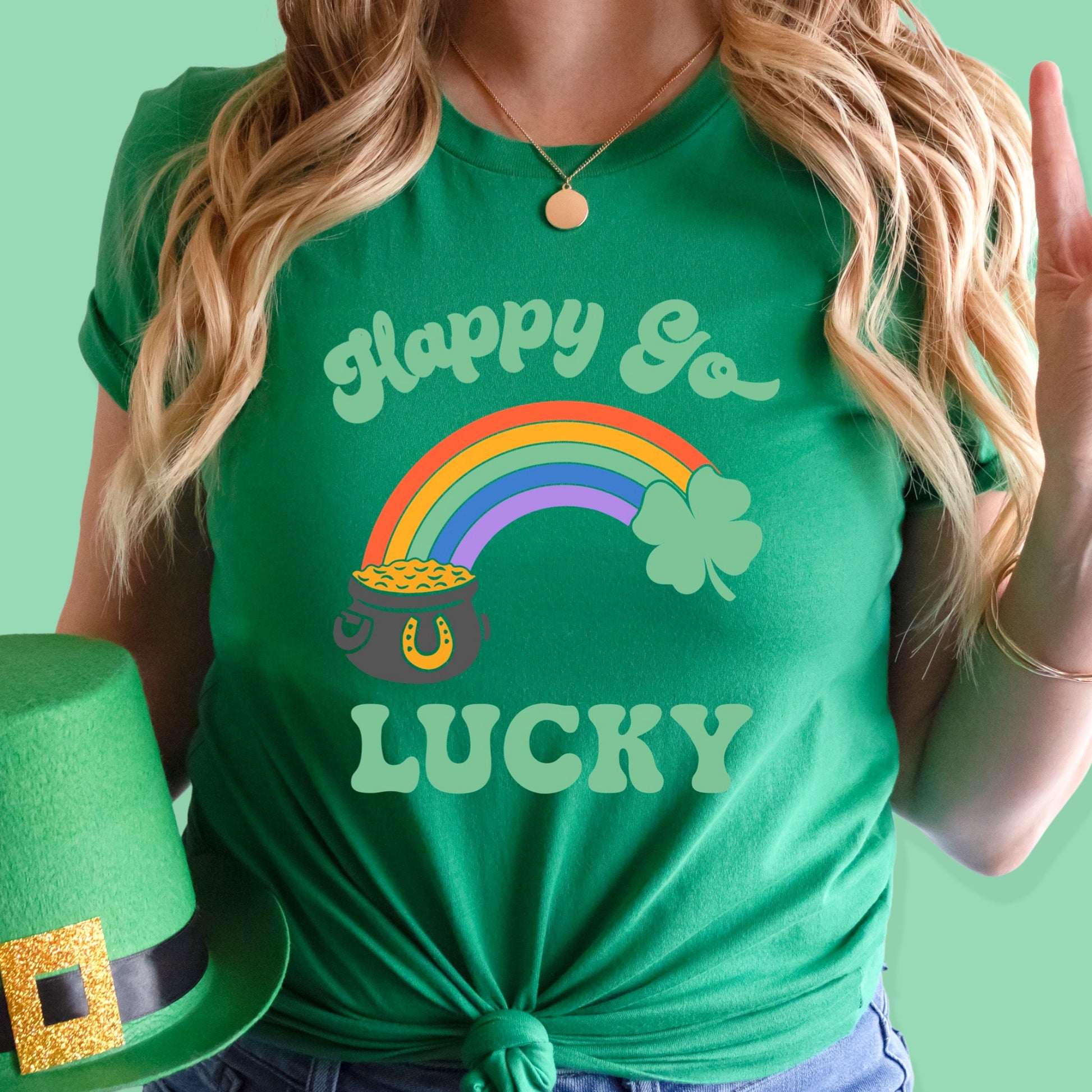 St. Patrick's day green iron on transfer with a pot of gold, rainbow, clover, and the phrase "Happy Go Lucky"