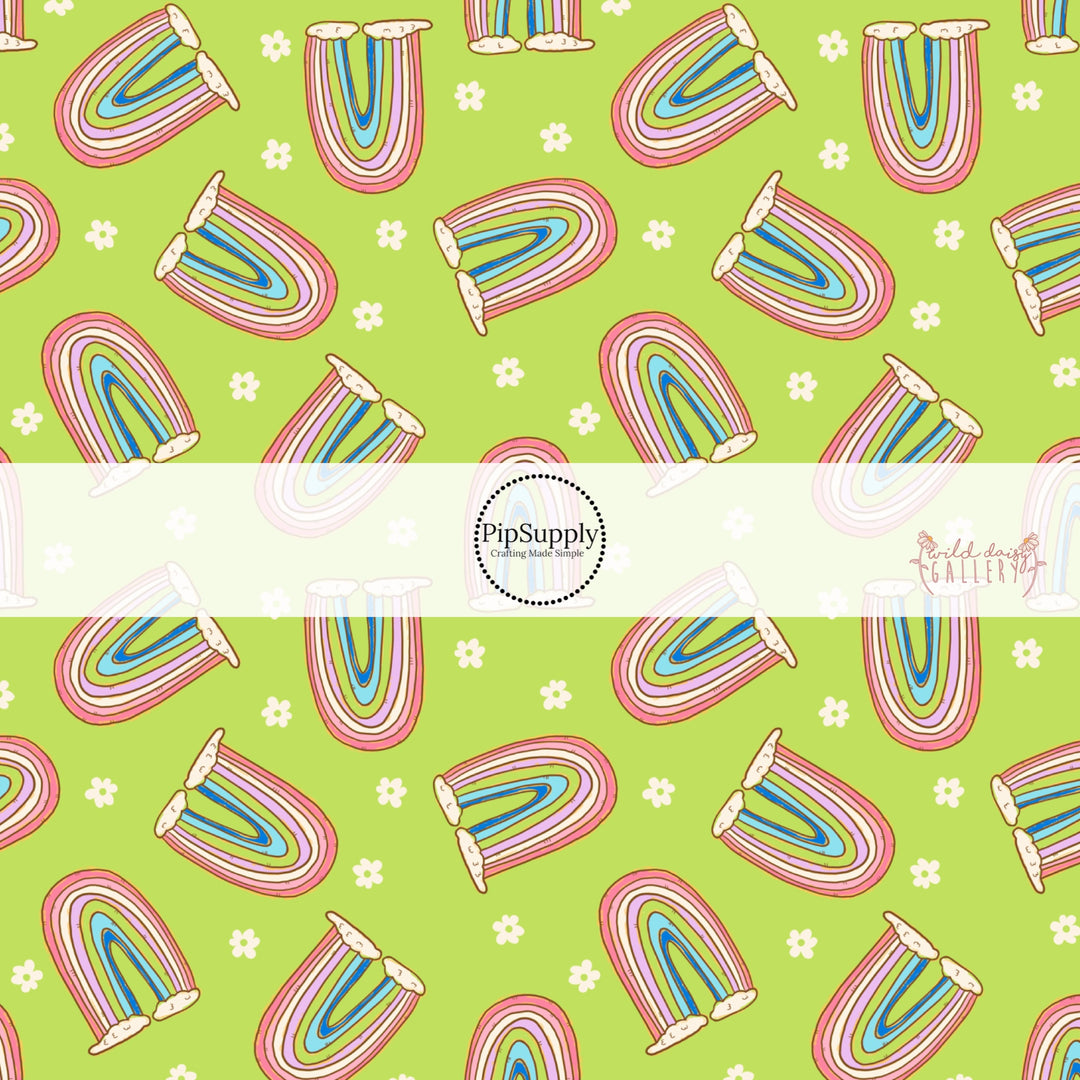 Light green fabric by the yard with white flowers and colorful rainbows