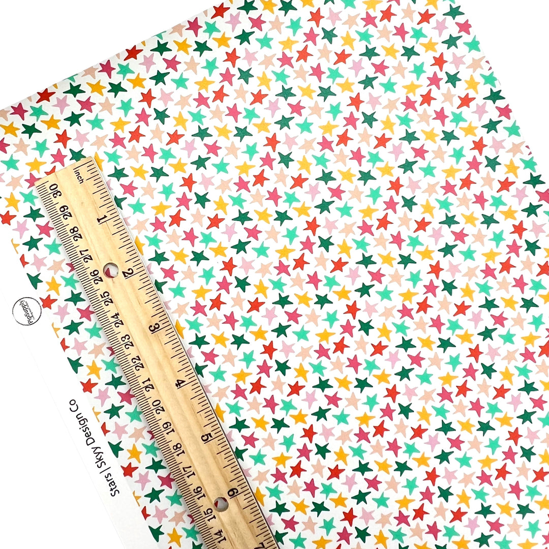 Pink, red, green, and yellow smiley faces on white faux leather sheets.