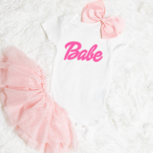 Pink Heat transfers that says "Babe" in a cursive font - Iron on Transfer 