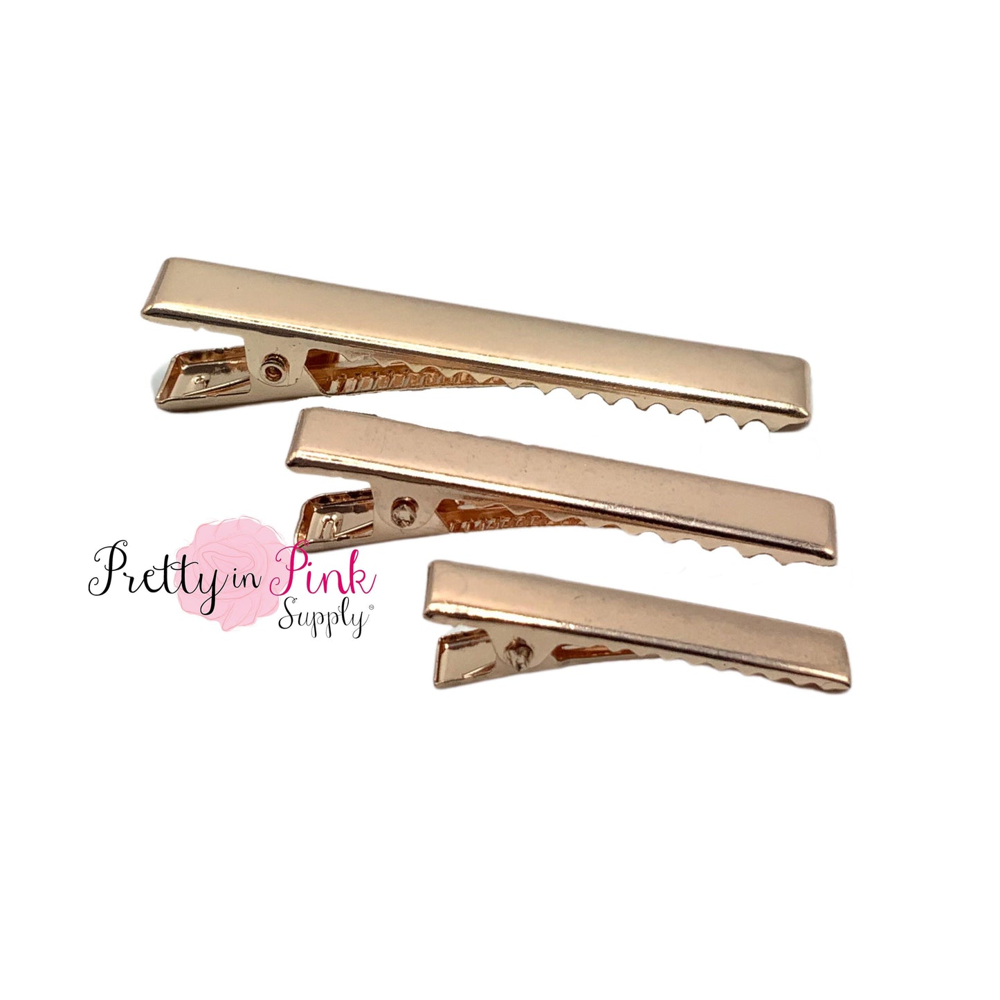 Group photo of Rose Gold alligator clips including sizes 2.375in., 1.75in., and 1.25in. top to bottom.