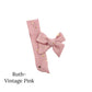 Small pink bow with gold stars on a white background