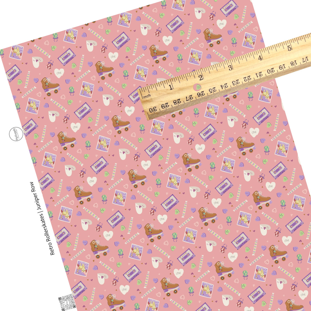 Brown skates, tapes, scattered candy, and letters on a pink faux leather sheet