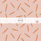 Pink fabric by the yard with scattered orange carrots