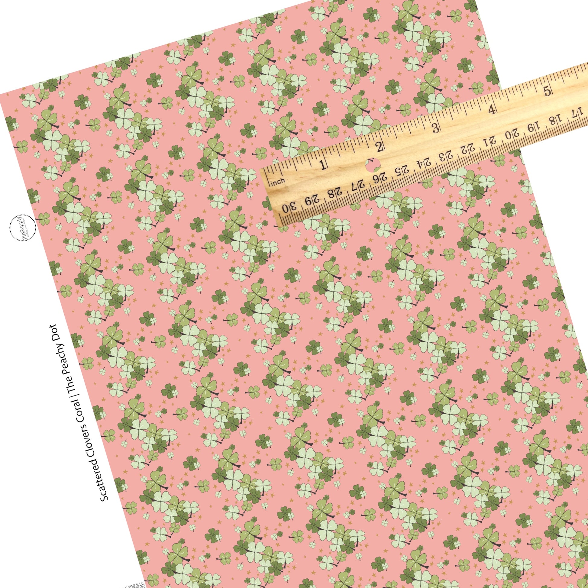 Dark green and light green different sized clovers on a coral faux leather sheet