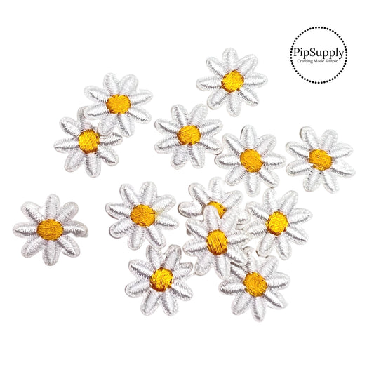 white pointed embroidered flowers with yellow centers