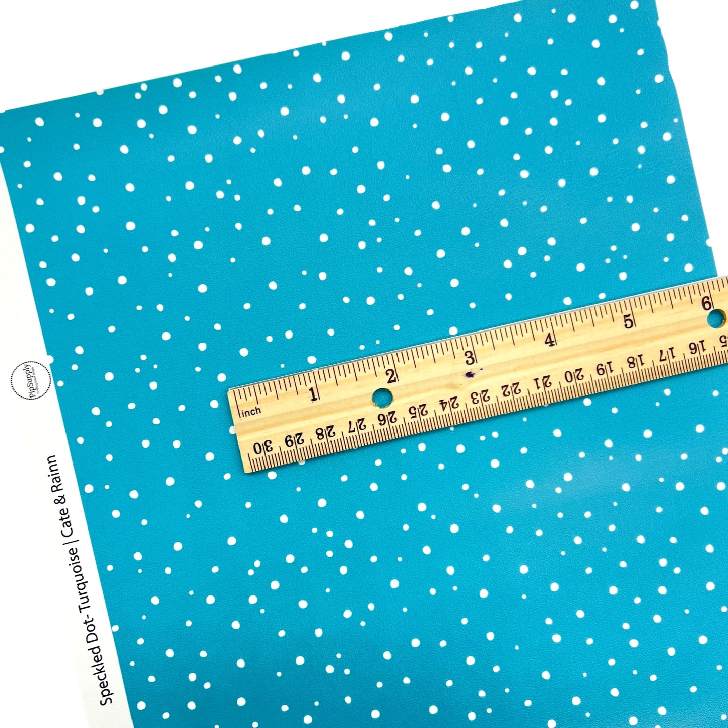 White dots on turquoise faux leather sheet.