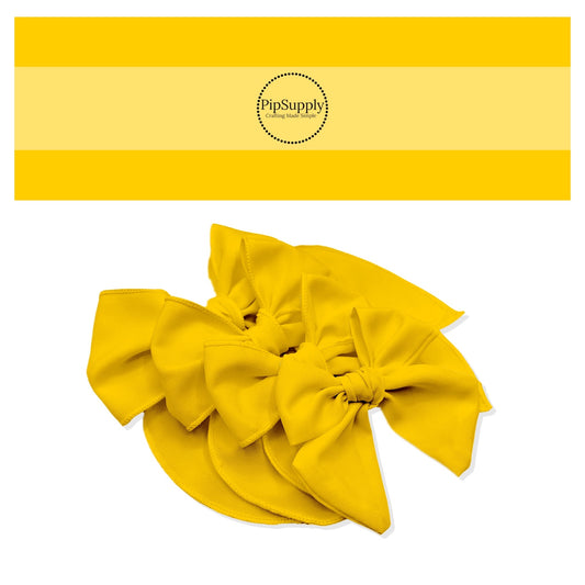 Tied spring, summer, or Easter solid color hair bow strips in bright golden yellow.