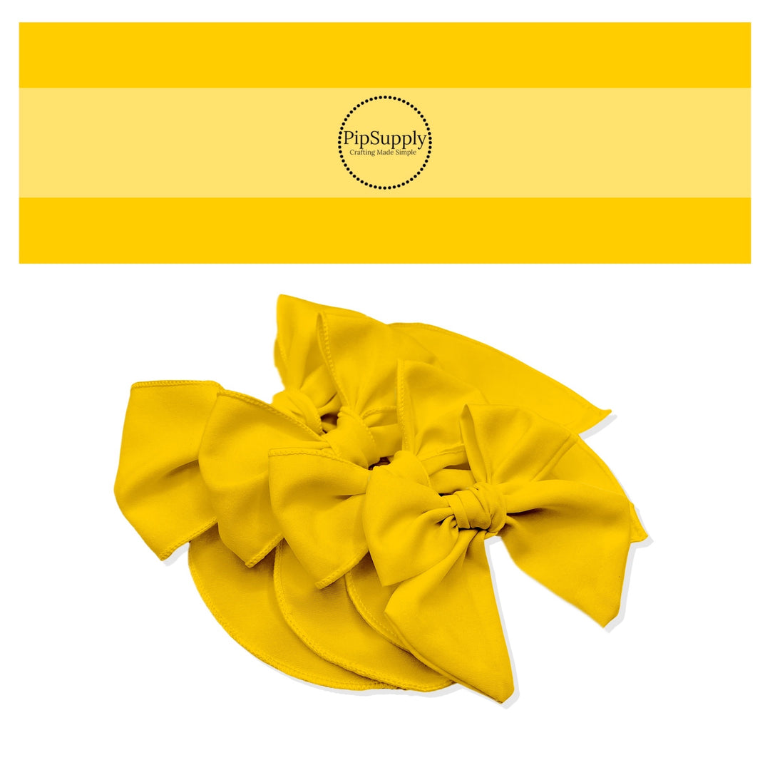 Tied spring, summer, or Easter solid color hair bow strips in bright golden yellow.