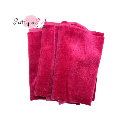 Folded over hot pink color stretch velvet fabric strip.
