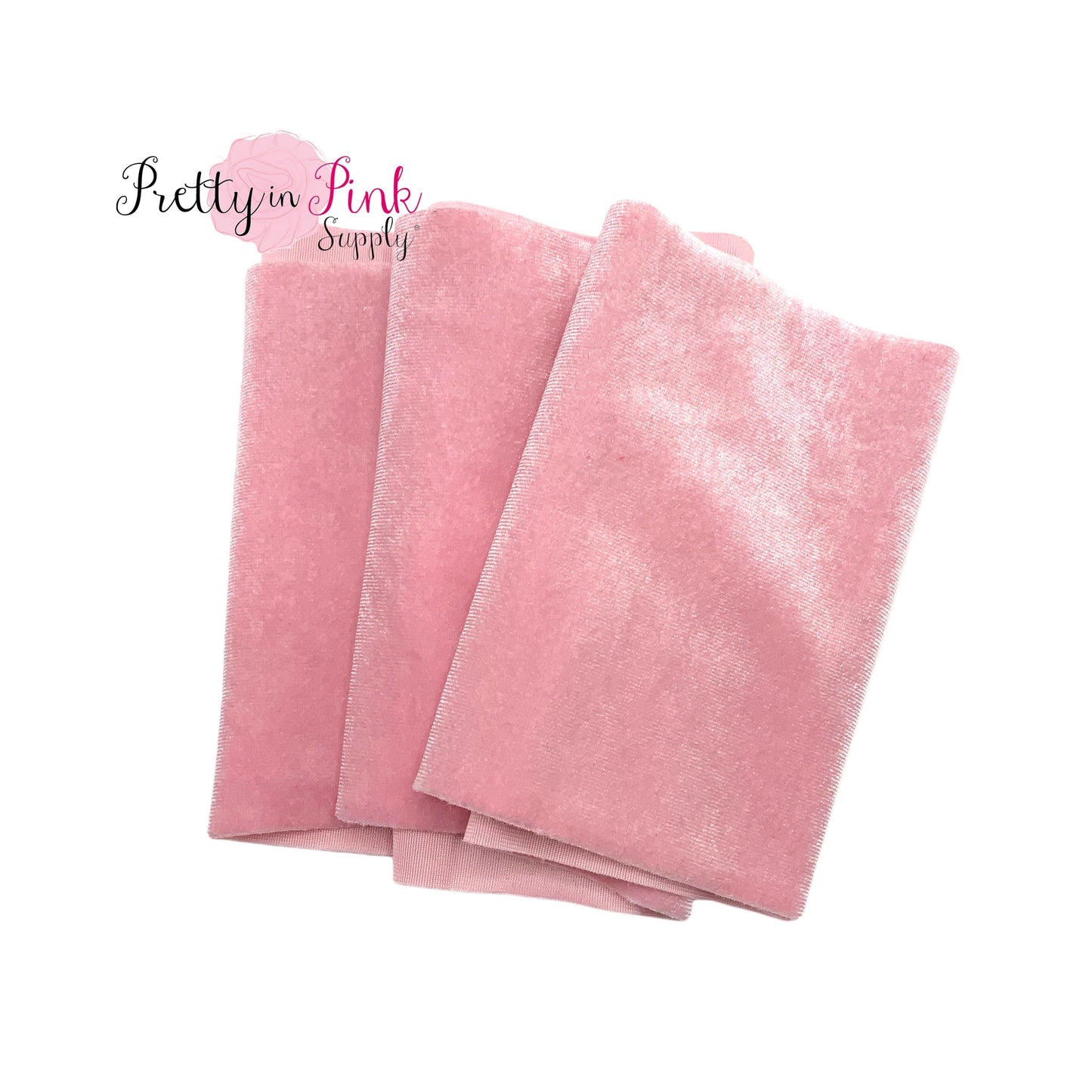 Folded over light pink color stretch velvet fabric strip.