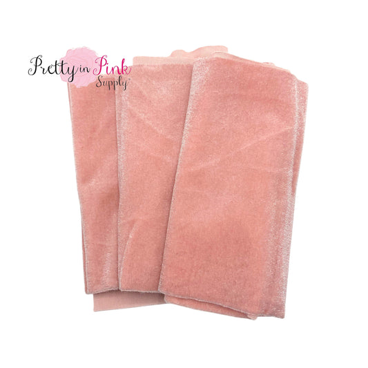Folded over pale pink color stretch velvet fabric strip.