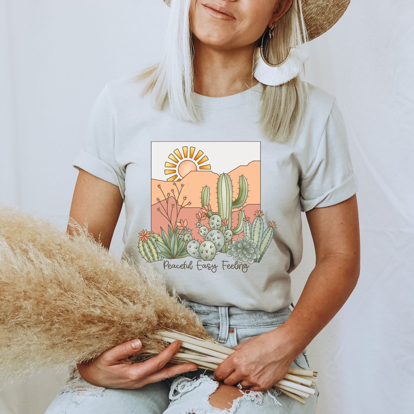 Western themed iron on heat transfer with cactus plants and sun rays. 