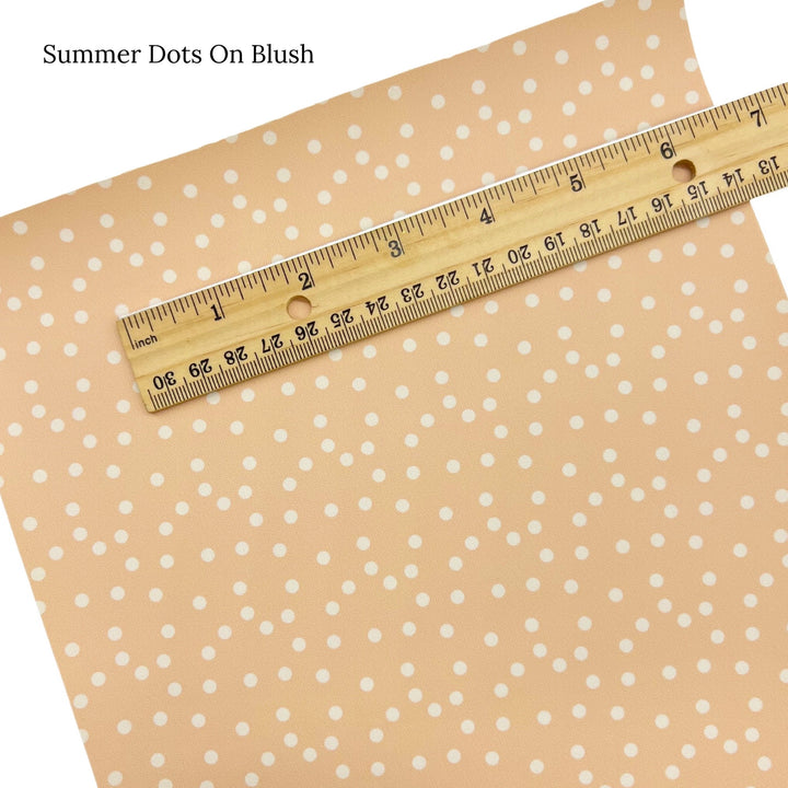 Cream polka dots on blush faux leather sheet.