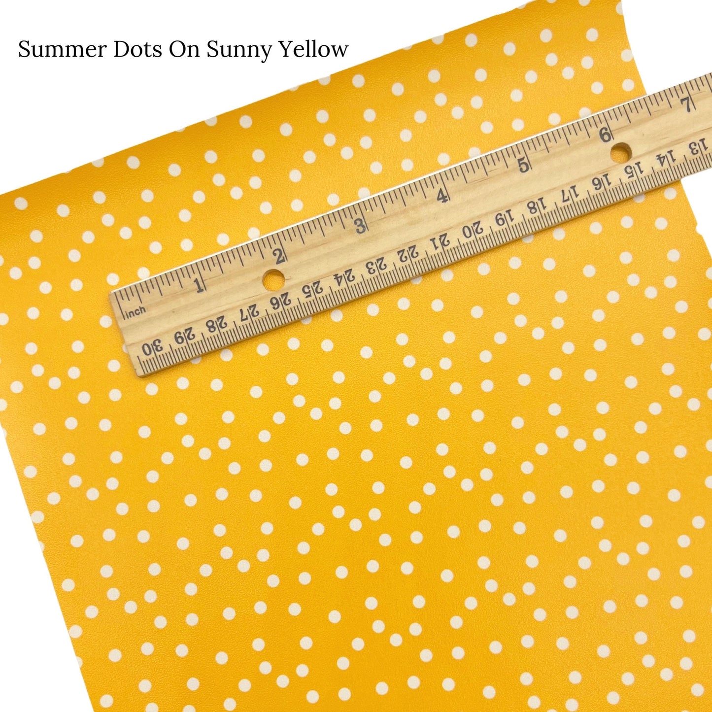Cream dots on bright yellow faux leather sheet.