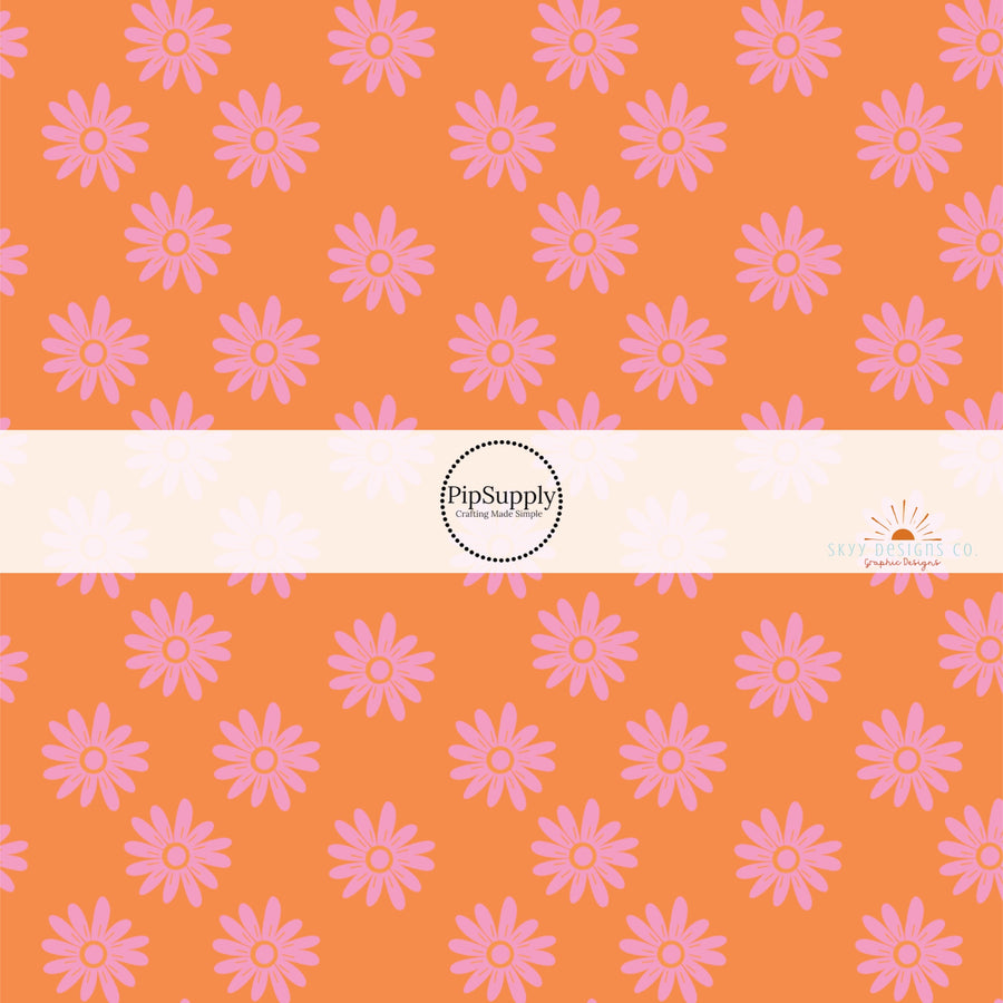 Vibrant orange fabric by the yard with pink scattered daises 