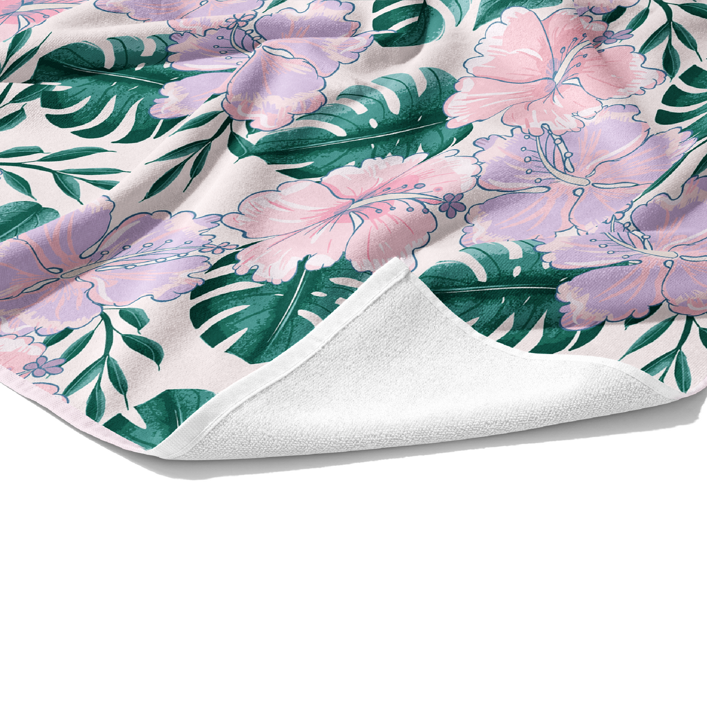 Plush white cotton towel with light pink and lavender tropical floral print on the front.