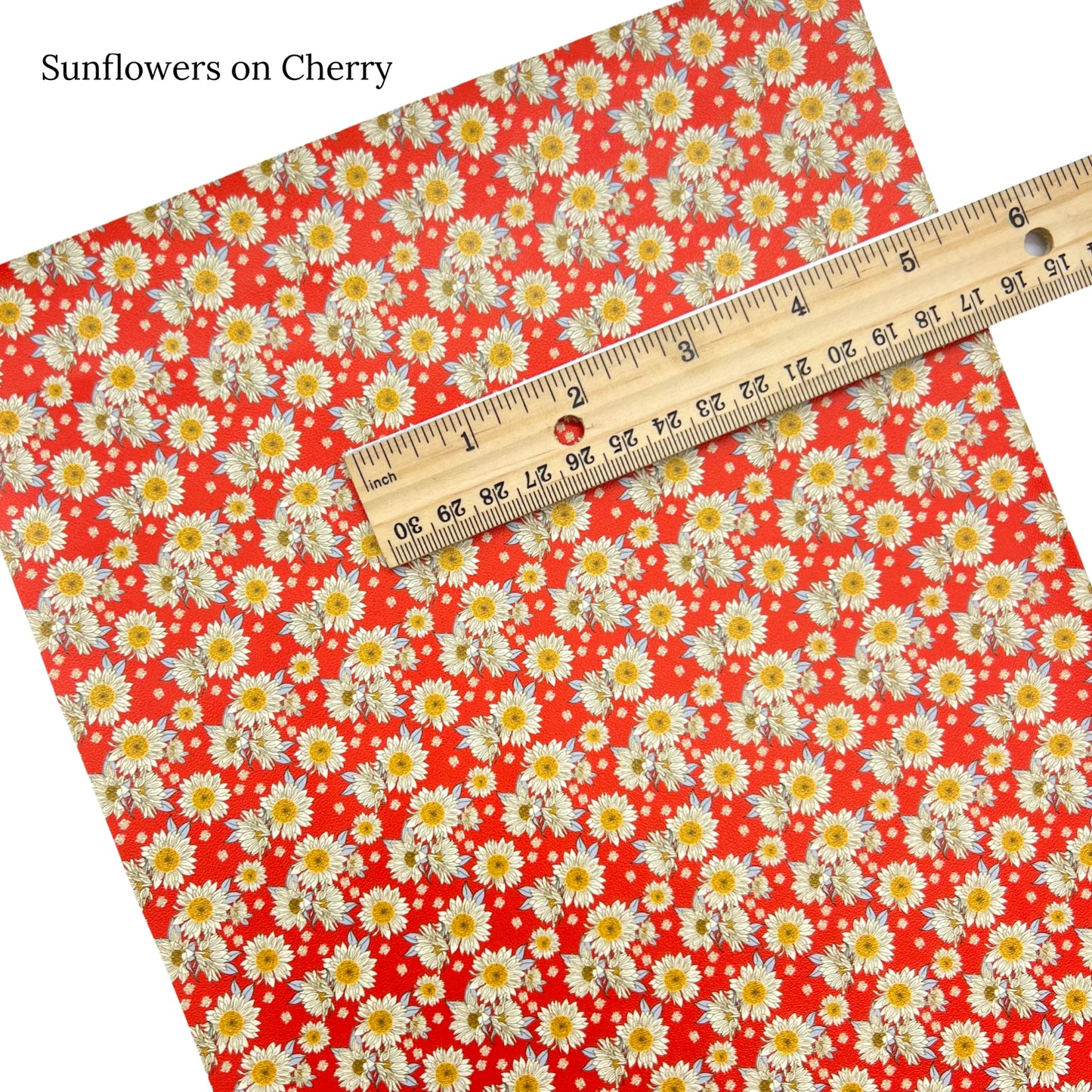 Sunflower clusters on cherry red faux leather sheet.