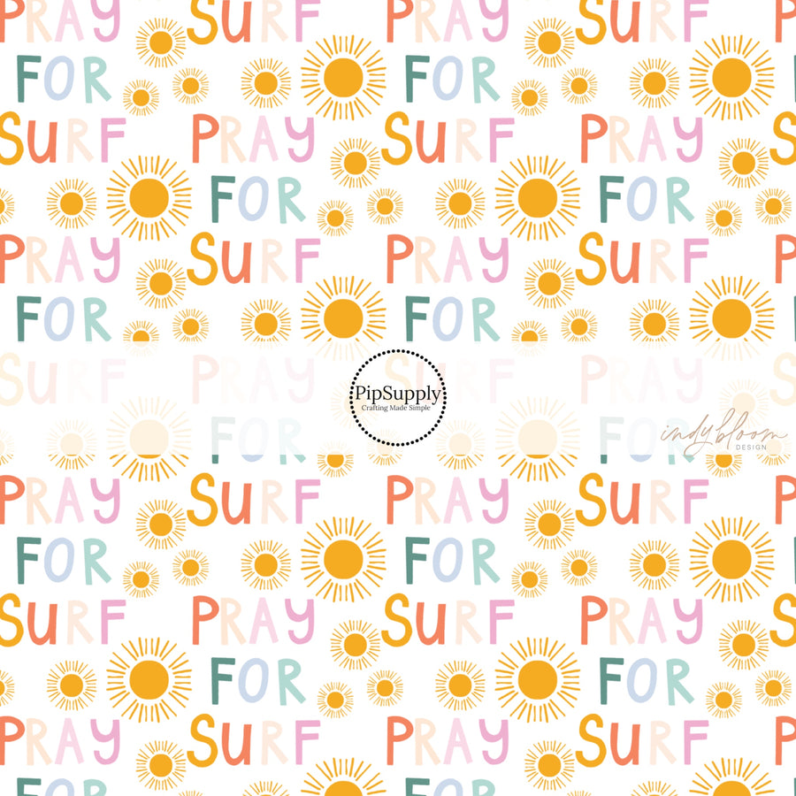 White fabric by the yard with suns and the phrase "Pray For Surf"