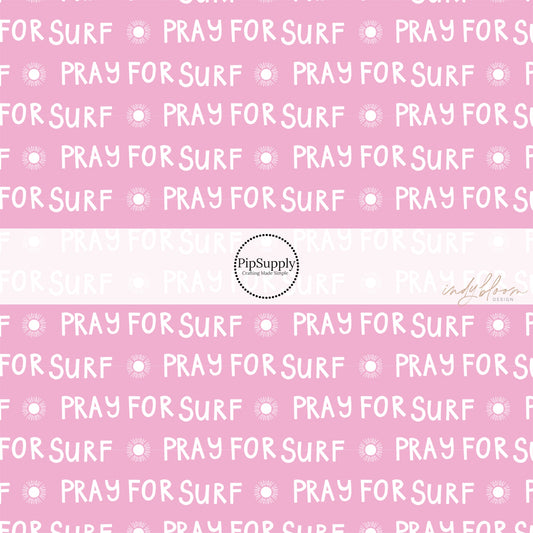Pink fabric by the yard with suns and the phrase "Pray For Surf"