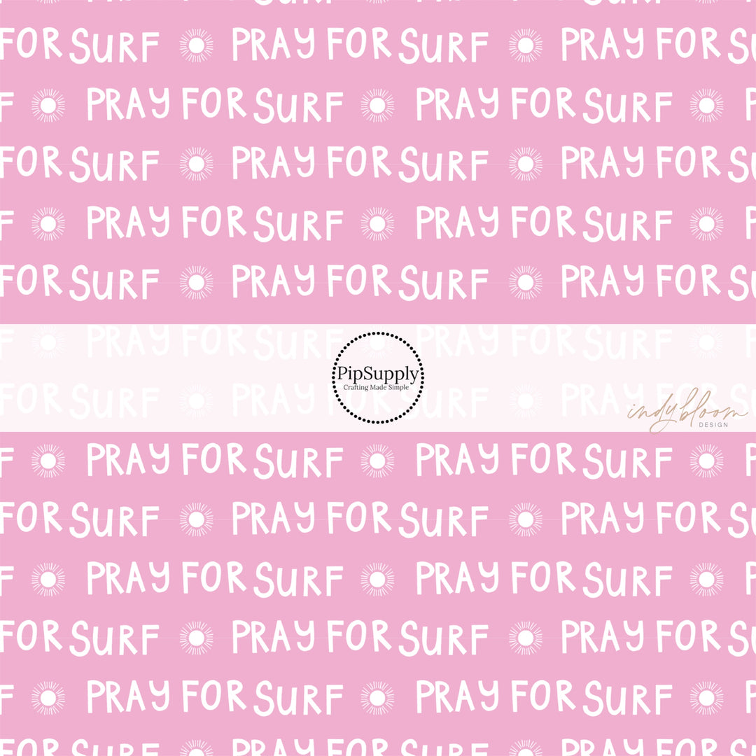 Pink fabric by the yard with suns and the phrase "Pray For Surf"